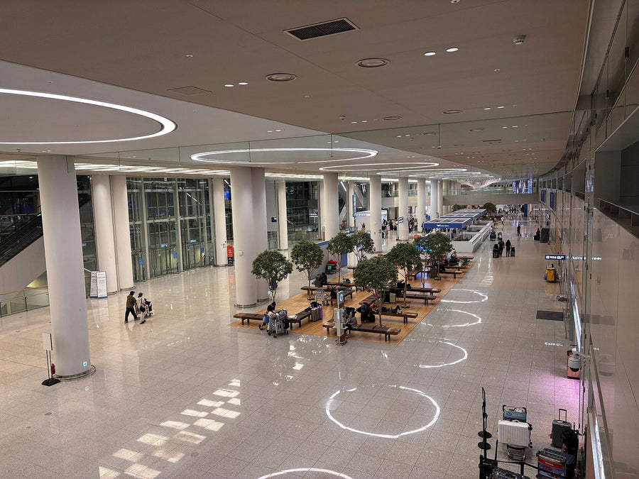 Korea arrival at Incheon International Airport: a bright main hall with white columns and indoor trees