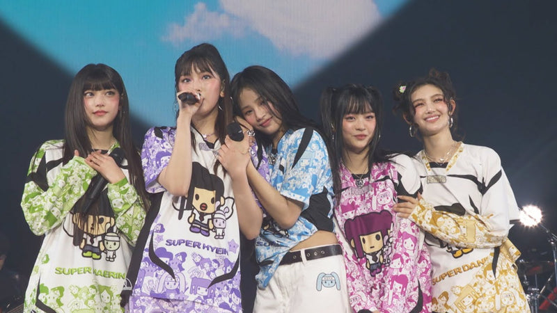The five NewJeans members together on stage at COUNTDOWN JAPAN 24/25 in a live video from their official channel