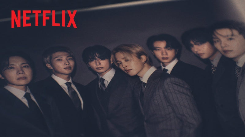 All seven BTS members in dark suits in the official trailer for the Netflix documentary BTS: The Return