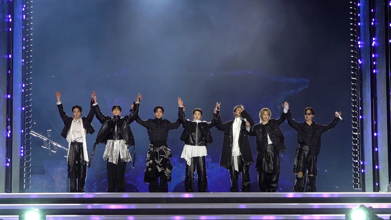All seven BTS members waving from the stage during BTS THE COMEBACK LIVE ARIRANG at Gwanghwamun Square