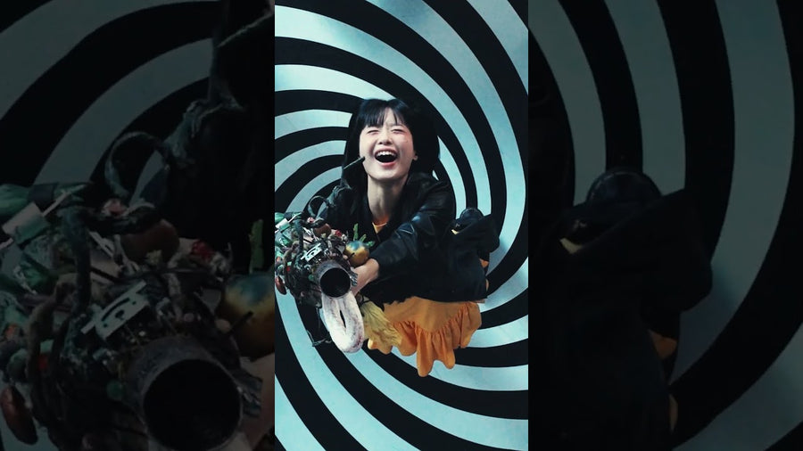 Hanroro laughing inside a black-and-white spiral set in the Game Over ? music video (Hanroro Official YouTube)