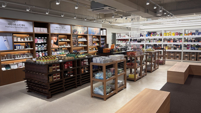 Pharmacy derma skincare wall beside the medicine aisles inside a modern Korean pharmacy in Seoul