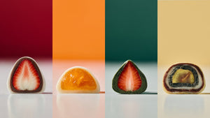 Hanjungsun chapssaltteok cut in half to reveal strawberry, tangerine and layered fillings against bold color blocks