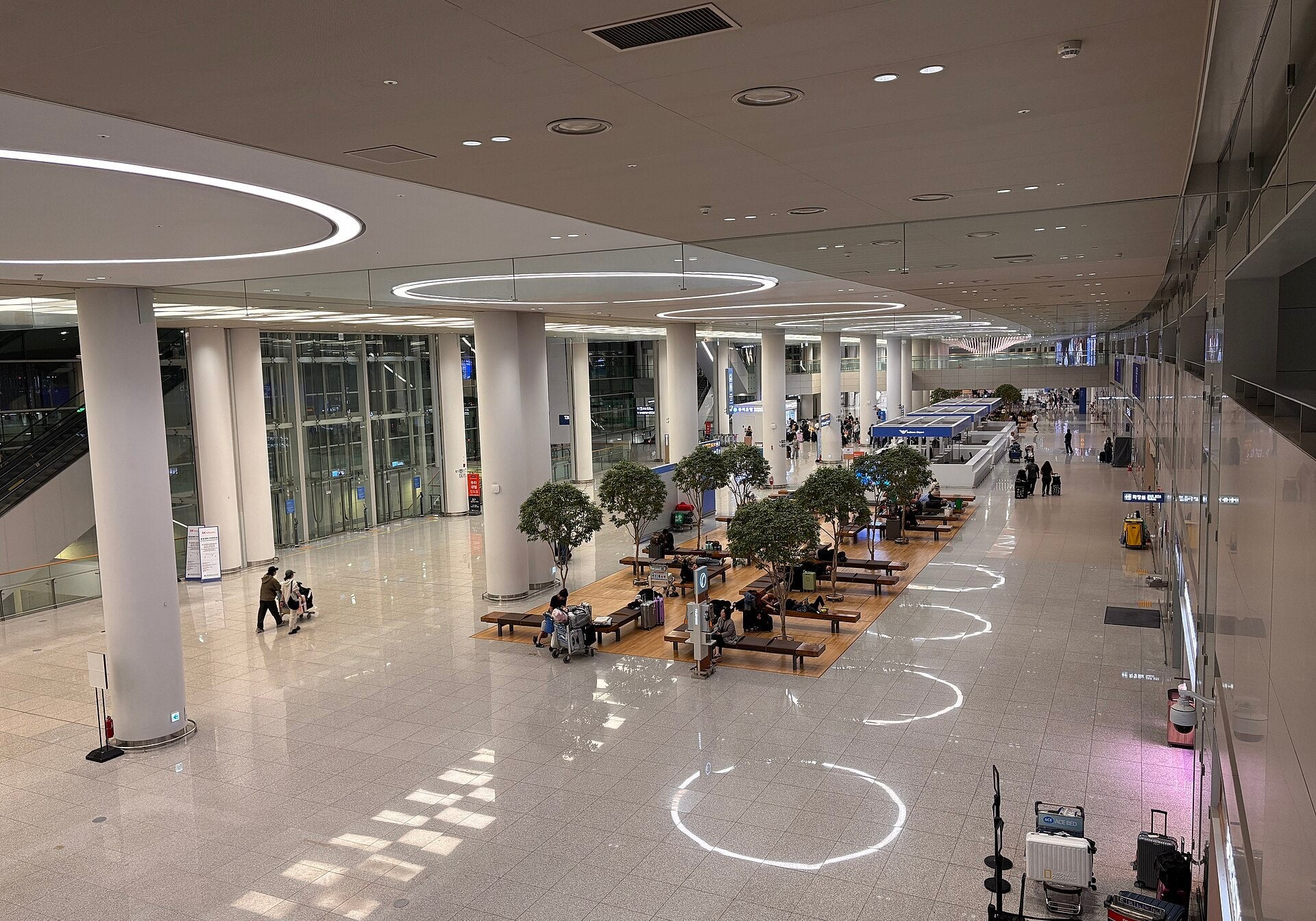 Korea arrival at Incheon International Airport: a bright main hall with white columns and indoor trees