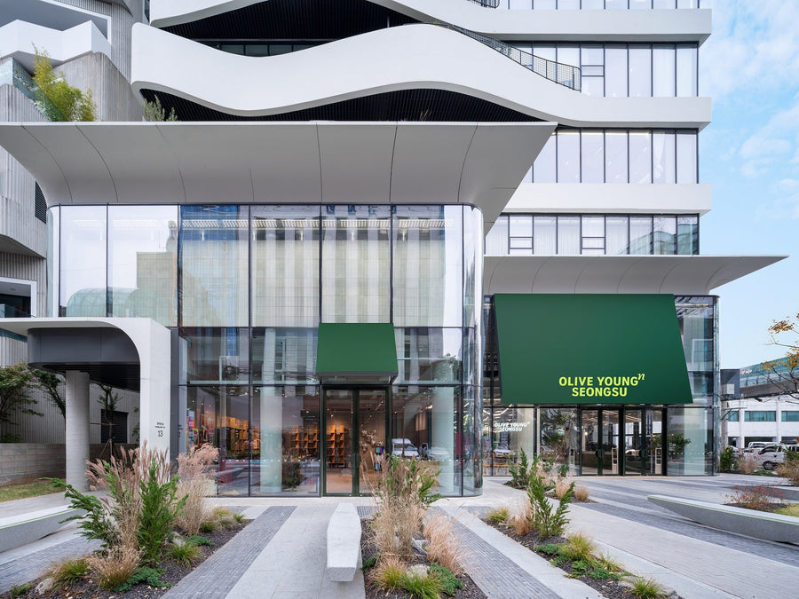Olive Young sale dates guide: the glass storefront of Olive Young N Seongsu under a clear Seoul sky