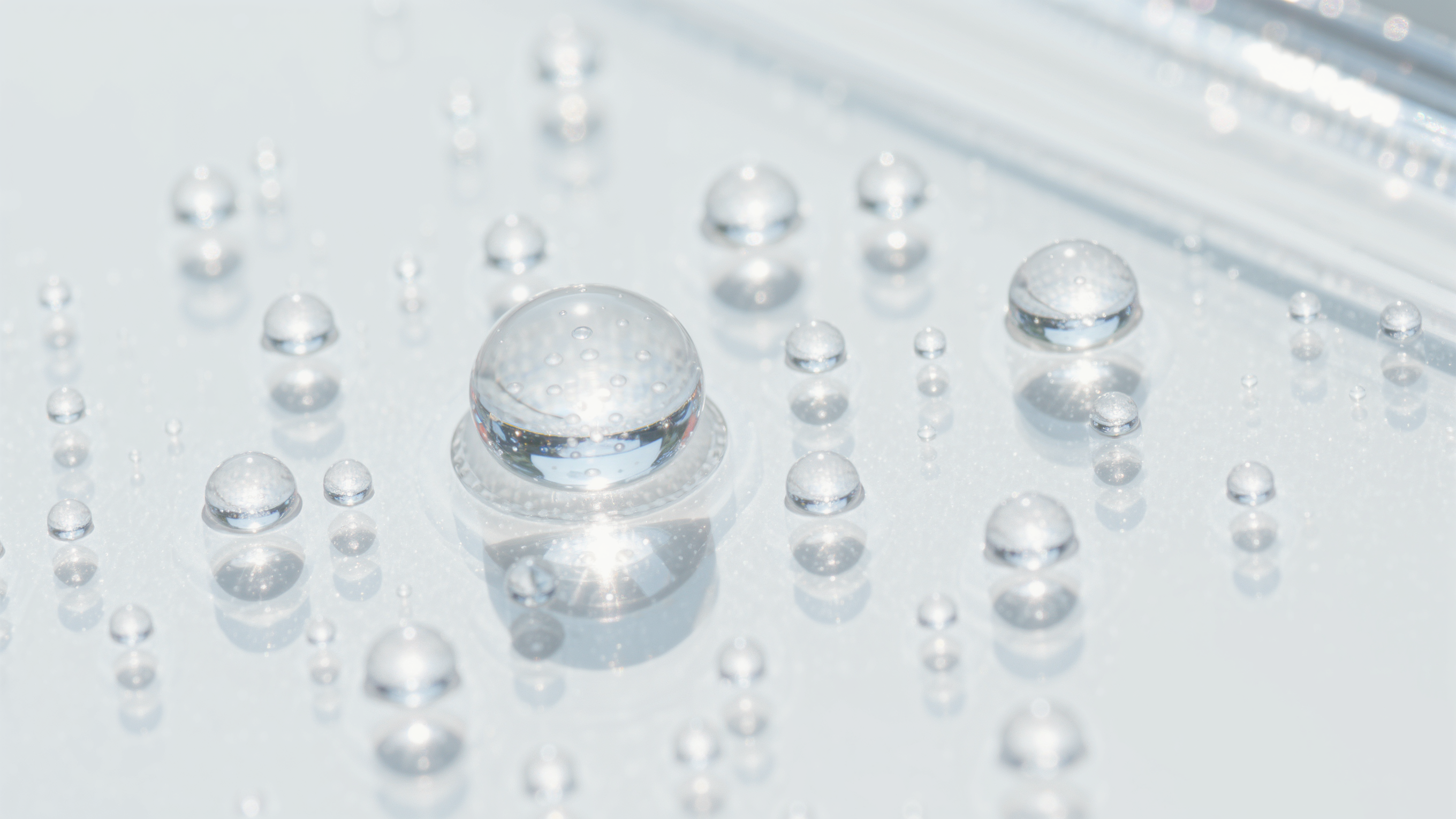 Translucent hydrocolloid patch dots scattered on a bright white surface