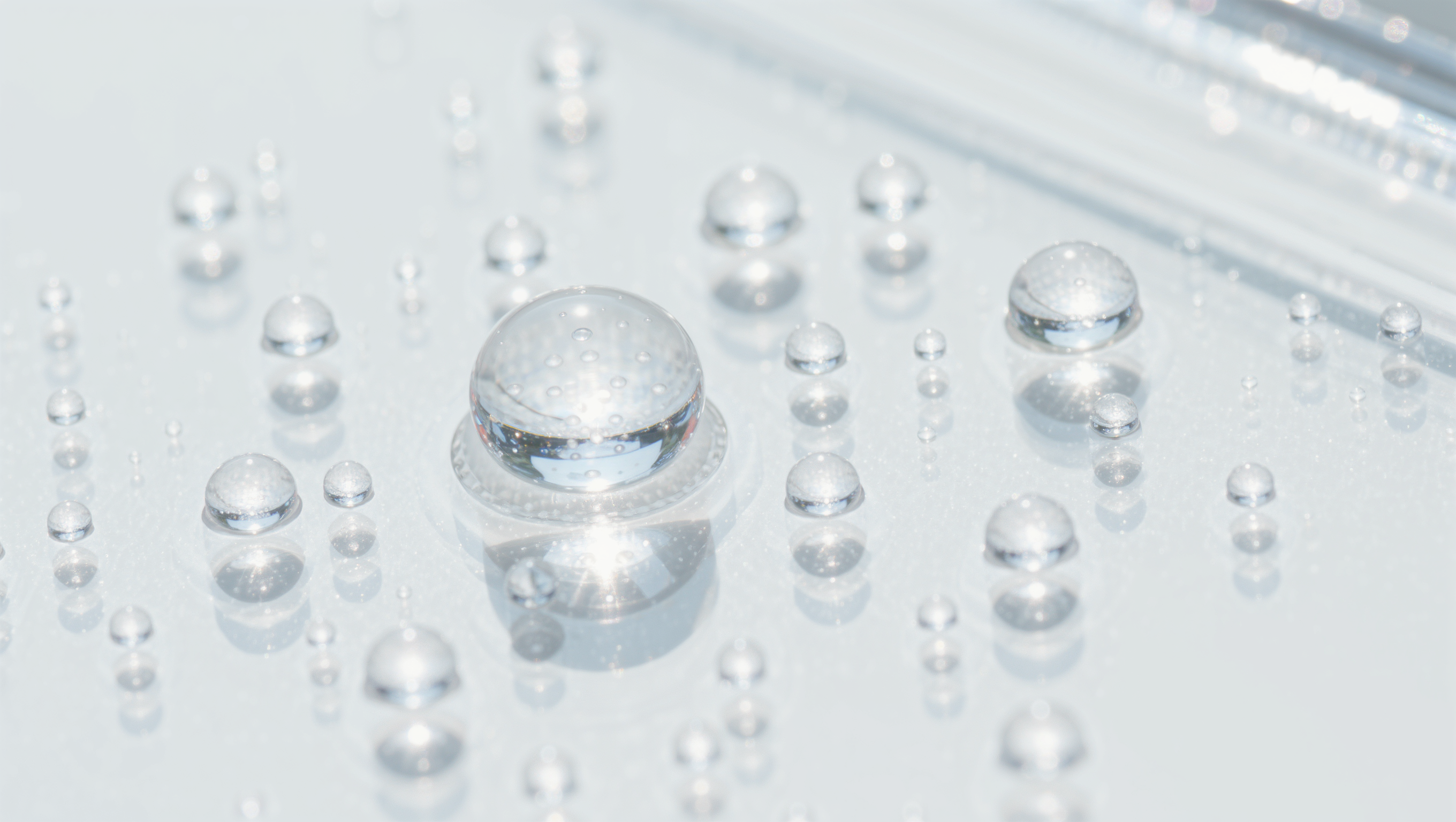 Translucent hydrocolloid patch dots scattered on a bright white surface