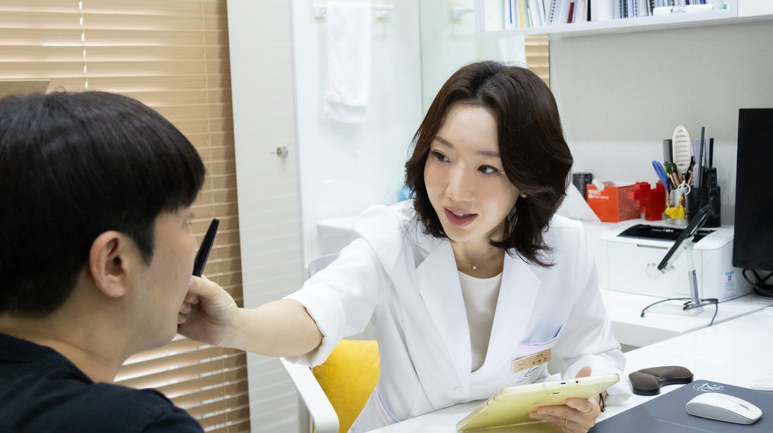 Doctor checking a patient's cheek during a skin consultation at a bright Seoul dermatology clinic