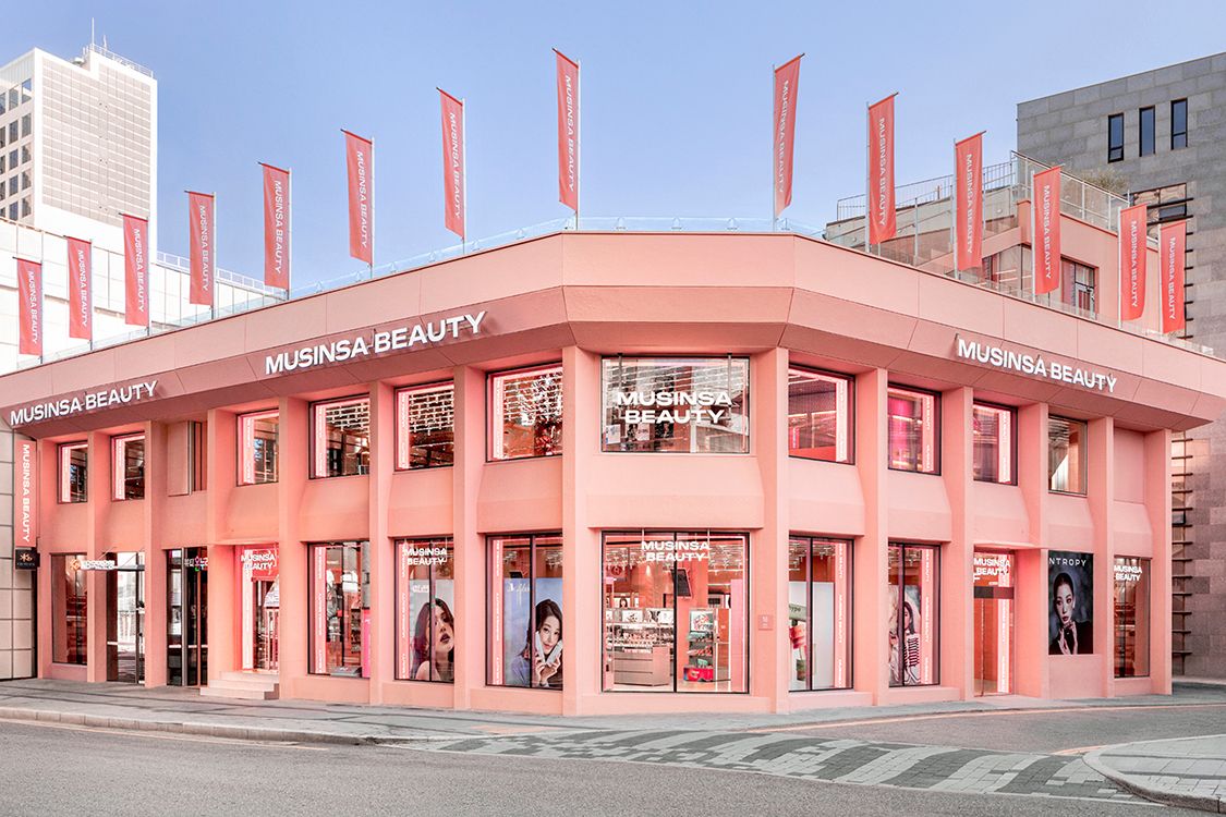 Musinsa Beauty Hongdae, a coral pink beauty flagship in Seoul with a pharmacy on its basement floor (Musinsa)