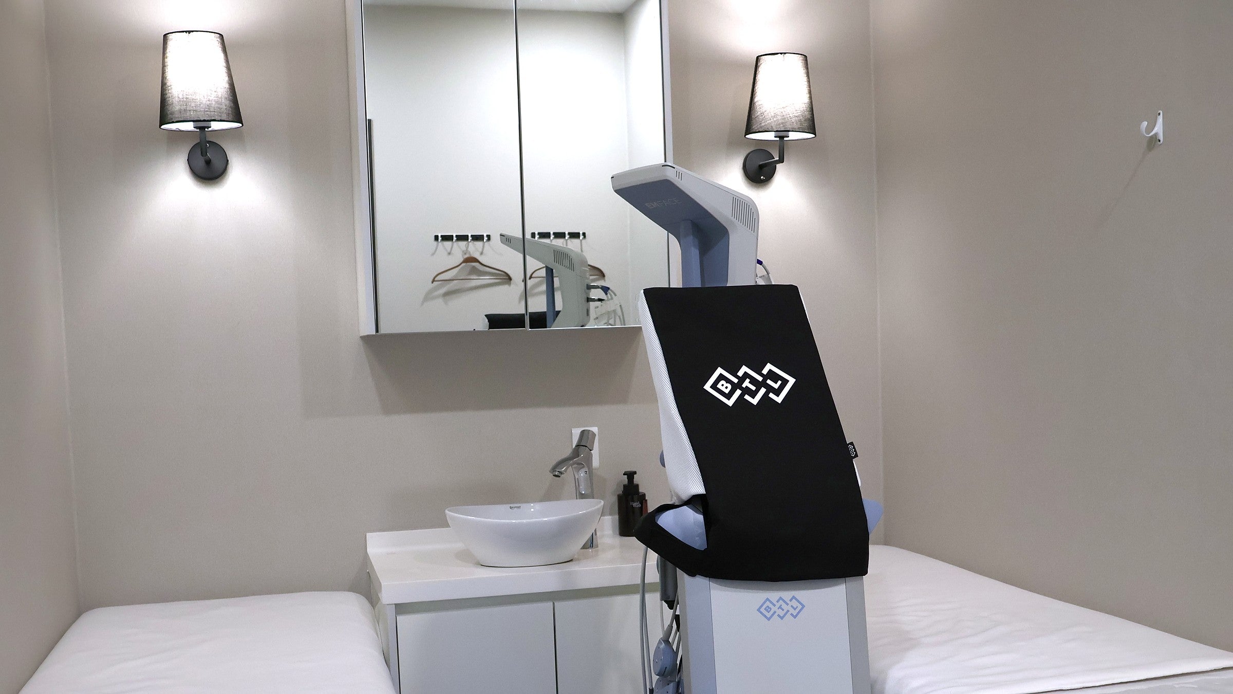 Korean skin management room in a Seoul clinic, with two treatment beds, a washbasin and a facial device