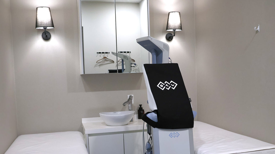 Korean skin management room in a Seoul clinic, with two treatment beds, a washbasin and a facial device
