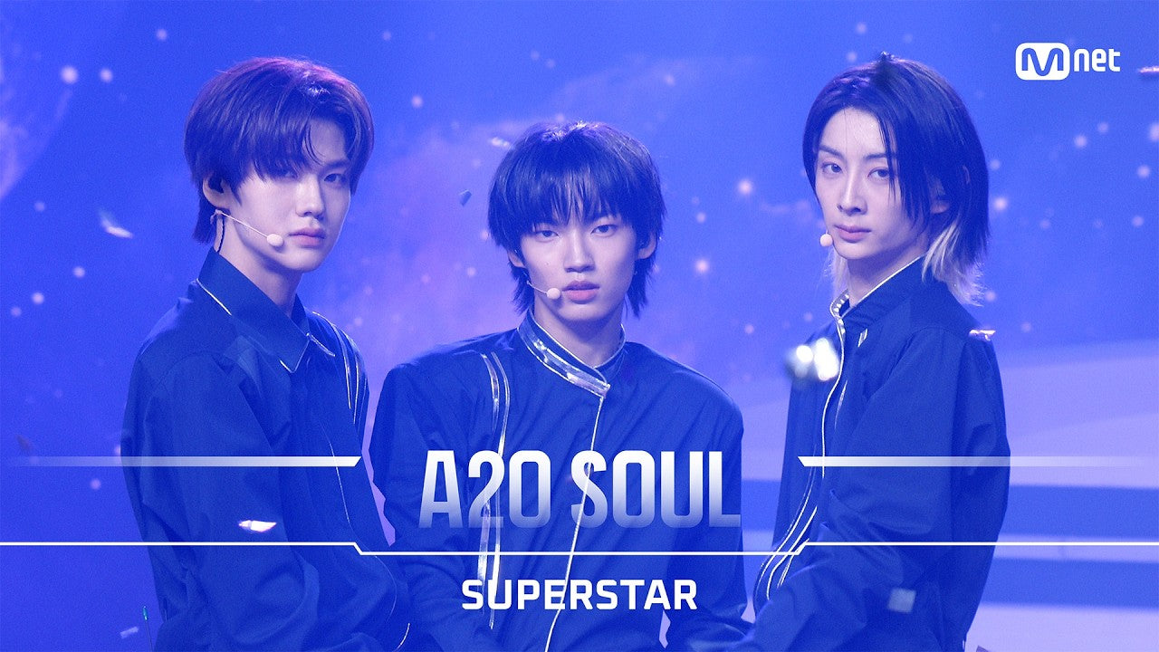A2O SOUL members in navy stage uniforms at the Welcome to Soulite debut show, on the title card for Superstar