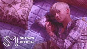 A RIIZE member lying on a lavender quilt in the 'Insomnia' music video teaser (SMTOWN Official YouTube)
