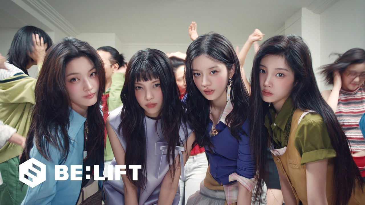 Four ILLIT members posing together in layered outfits in the BREAK EVEN teasing video