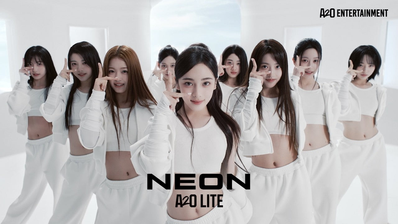 A2O LITE's nine members in white outfits in the official NEON music video