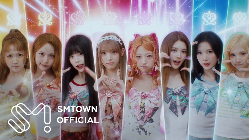 Hearts2Hearts members in colorful magical-girl outfits lined up in the ICONIC HEART music video (SMTOWN Official YouTube)