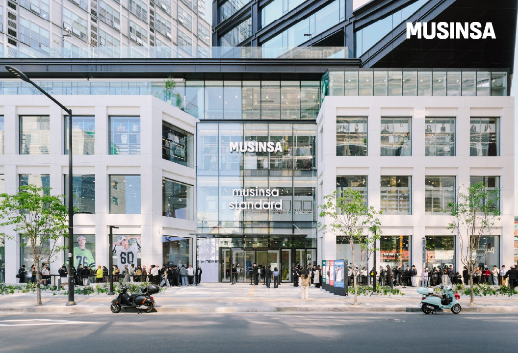 Musinsa Megastore Seongsu on Seongsu-iro in its opening week, with shoppers lined up along the white facade