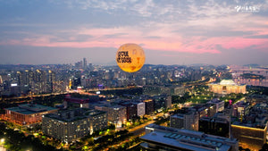 Seoul Dal glowing at sunset over Yeouido, National Assembly dome and Han River below (VisitSeoul TV Official YouTube)