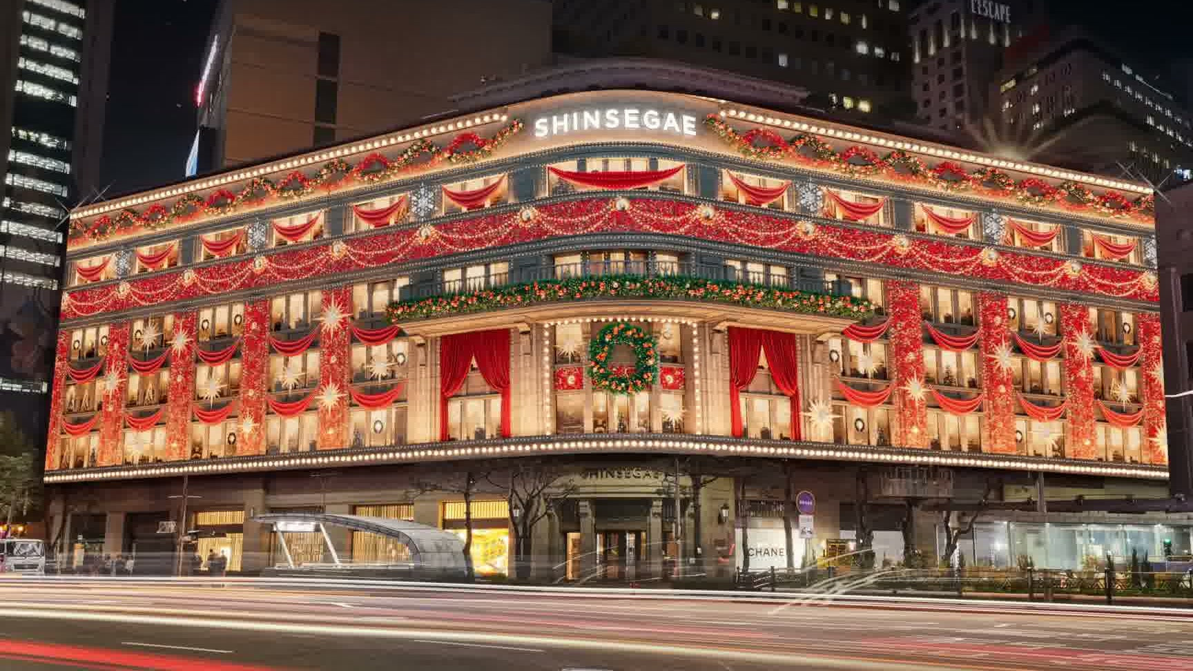 Shinsegae's Myeongdong facade dressed in red Christmas garlands at night (Shinsegae Department Store Official YouTube)