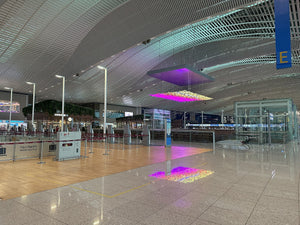 Suneung day flights: the bright departure hall of Incheon Airport Terminal 2 with check-in rows and a glowing light art