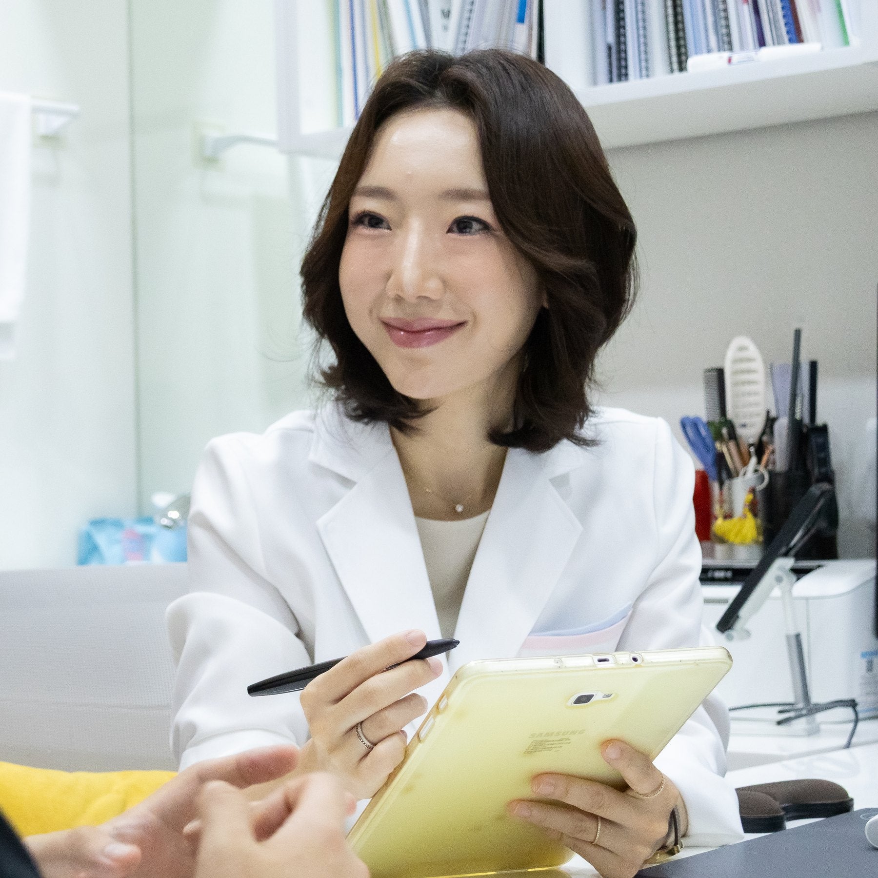 Dr. Wonjin Cho listening to a patient at CHAI Clinic