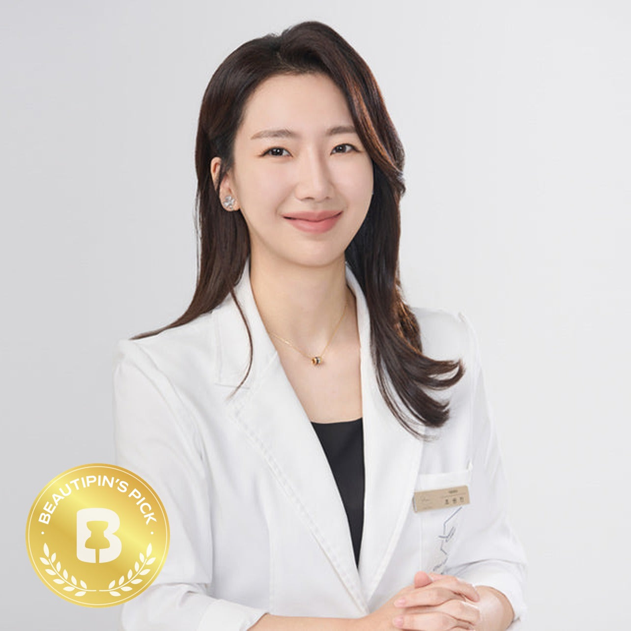 Dr. Wonjin Cho, Chief Director of CHAI Clinic, with the BeautiPin's Pick badge